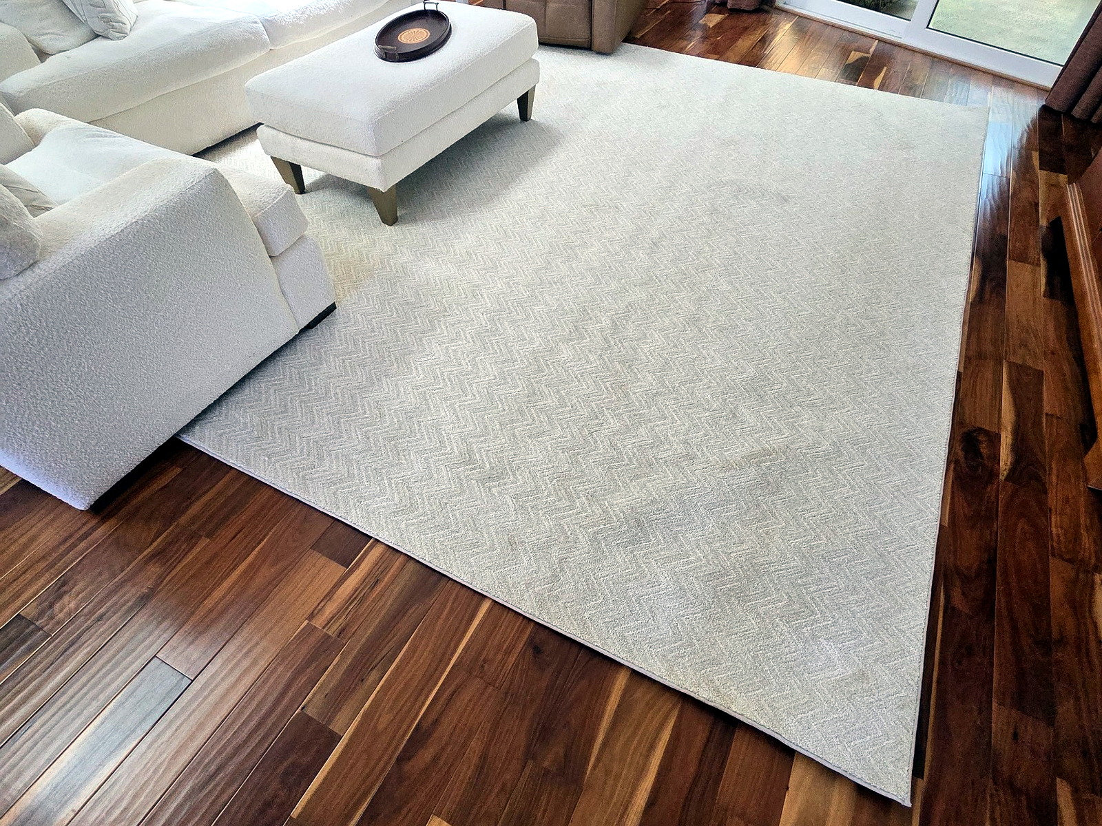Rolled rugs and soft goods placed with care inside a residence