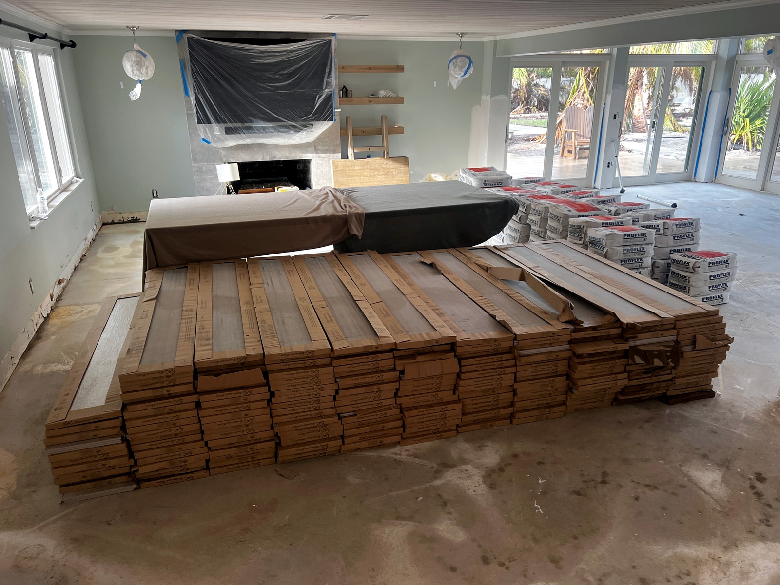 Boxes of hardwood flooring and tile delivered inside a finished home