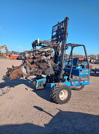 Blue Princeton piggyback forklift carrying a scrap engine assembly in an outdoor yard