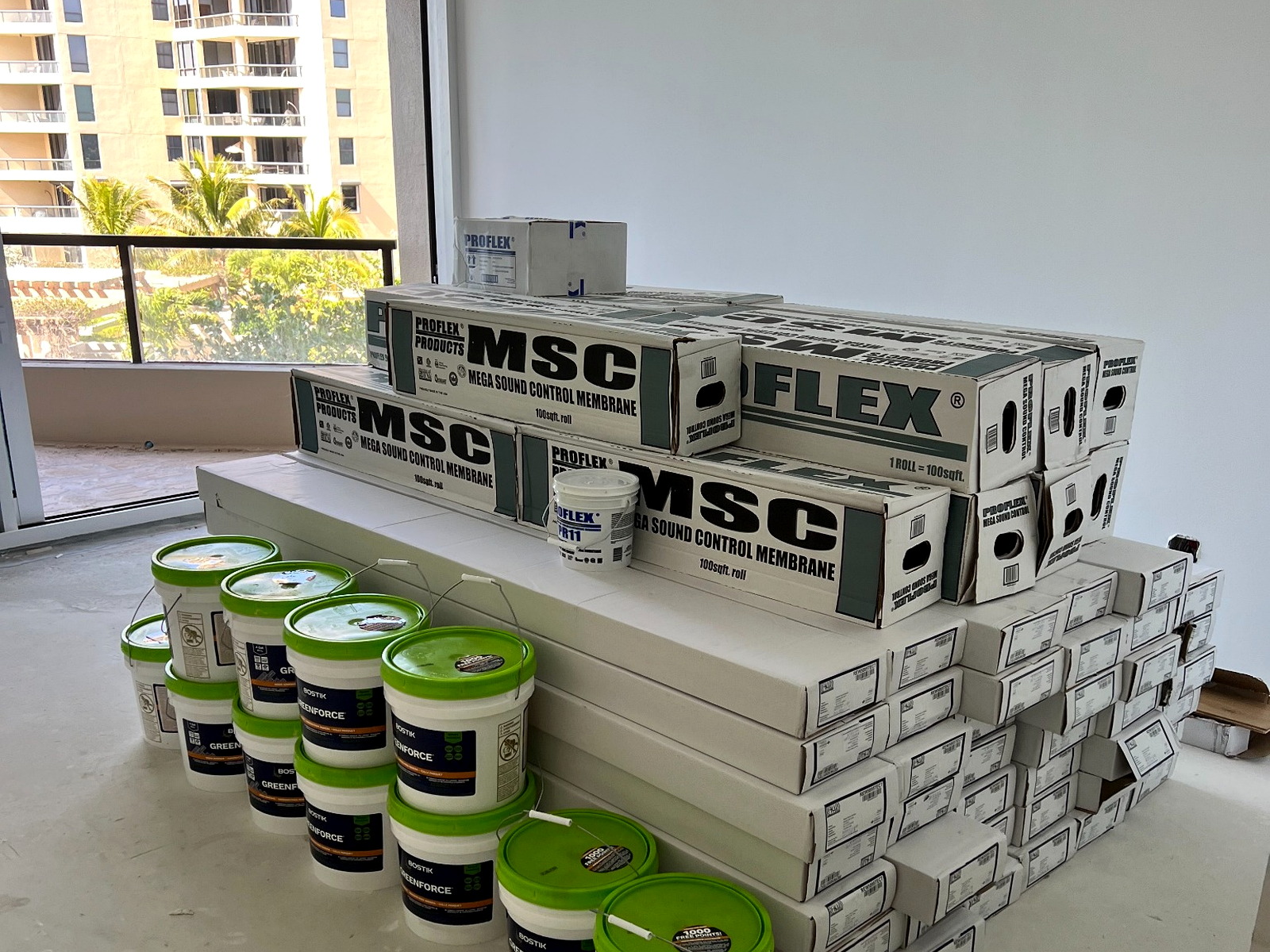 Pallets of construction materials staged inside a Greater Tampa Bay luxury condo for final-mile delivery