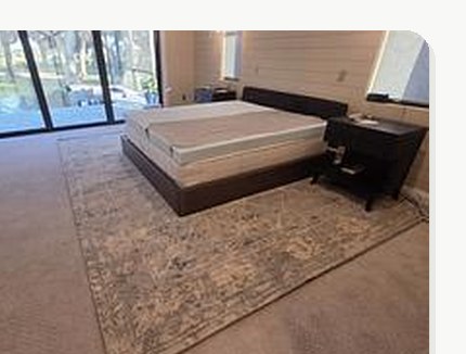 Bedroom mattress and bedframe delivered and set up over a finished rug