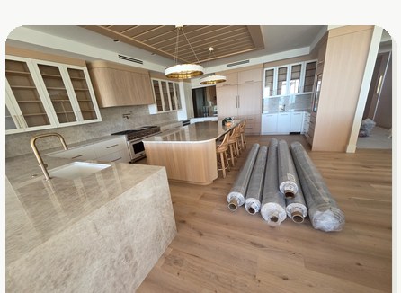 Room-of-choice placement of wrapped flooring bundles inside a finished kitchen